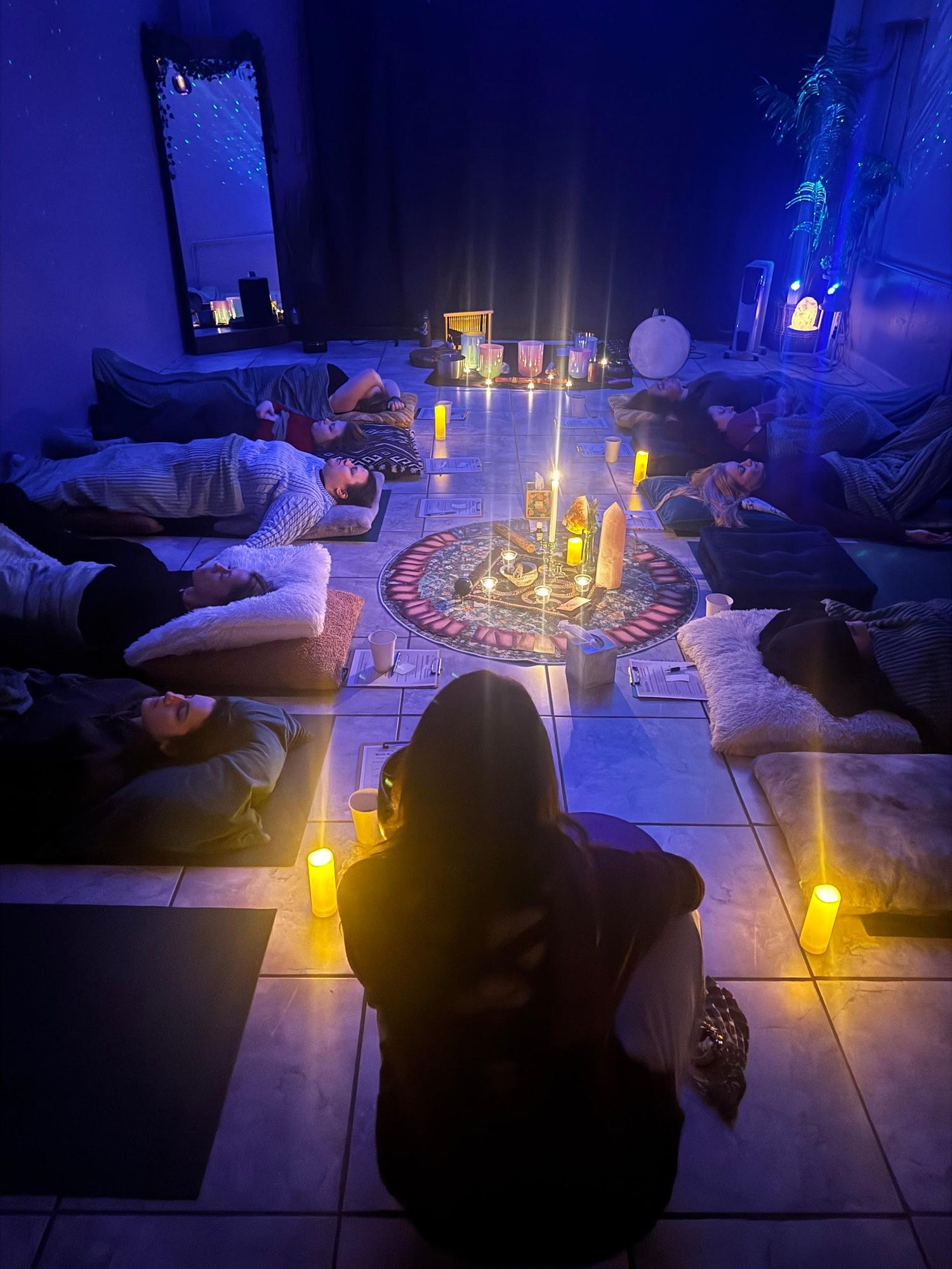 A group sound bath ceremony by candlelight